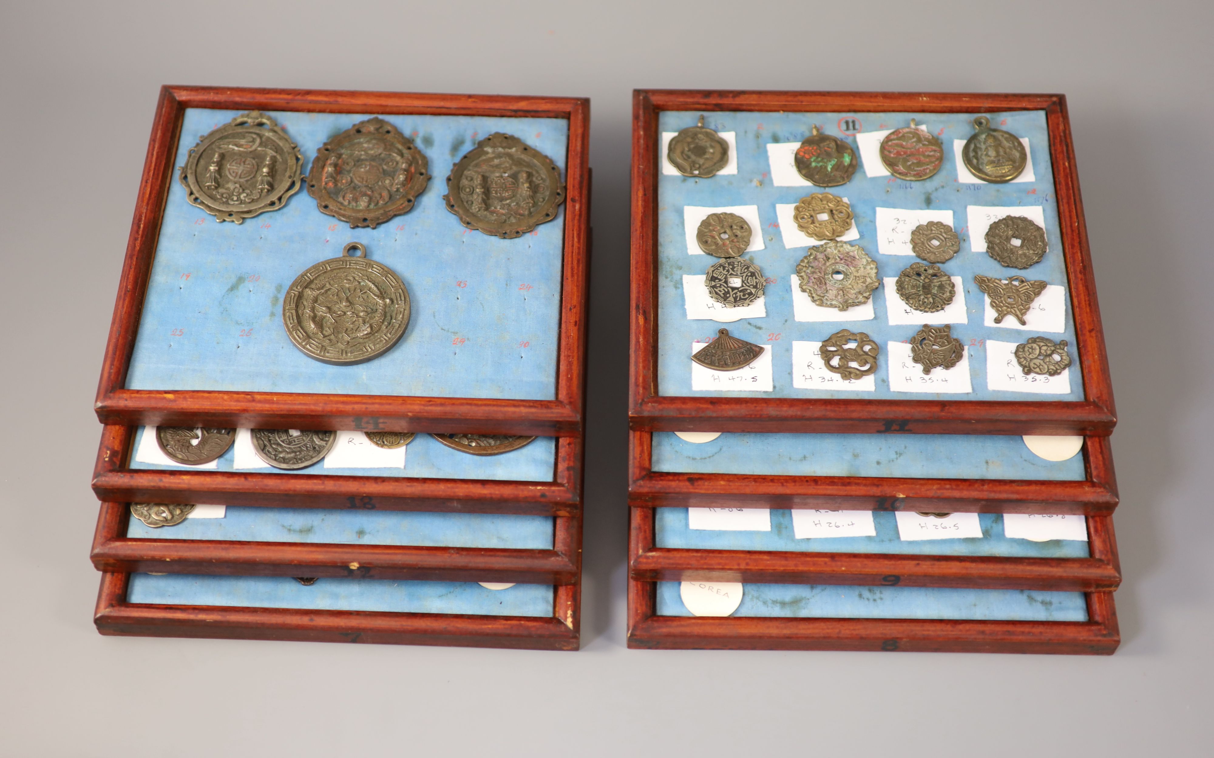 A group of 99 Korean bronze and metal amulets or charms, 19th/20th century